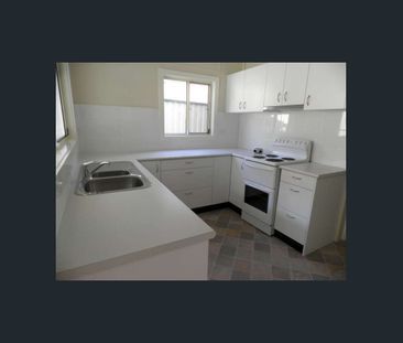 Cozy Three-Bedroom House with Leafy Backyard - Photo 4