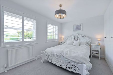A beautifully refurbished four-bedroom family home featuring versatile living space, a stunning open-plan kitchen/dining area, separate utility room, and stylish modern interiors throughout. - Photo 5
