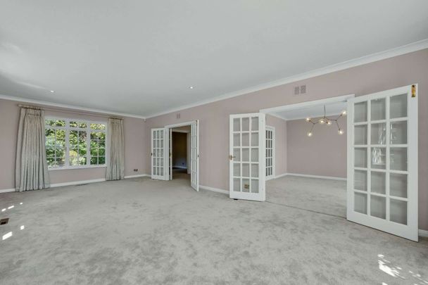An attractive six bedroom family home set within mature grounds on the prestigious St George's Hill Estate, offering generous family accommodation, a swimming pool and far-reaching views. - Photo 1