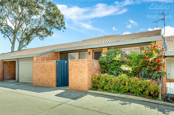 Fantastic Single Level Two Bedroom Townhouse with Garage - Photo 1