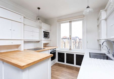 An impressive top-floor two bedroom apartment combining generous proportions, abundant natural light and outstanding park views in the heart of Primrose Hill. - Photo 4