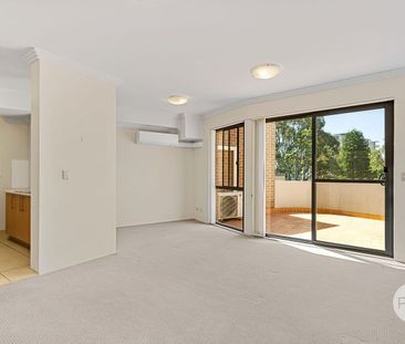 SUNDRENCHED TOP FLOOR UNIT IN CONVENIENT SETTING - Photo 1