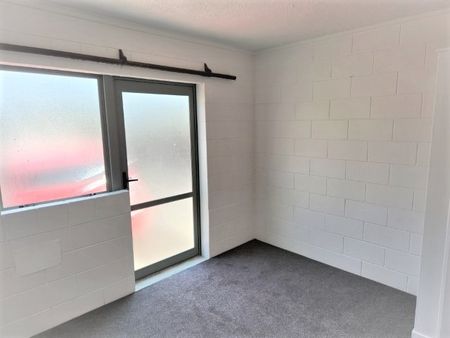 A two-bedroom, one-bathroom unit offering a generous open-plan living area, kitchen, laundry, and bathroom. - Photo 4