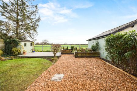 A three bedroom semi-detached family home with a garage and driveway parking in the village of Culcheth. - Photo 3