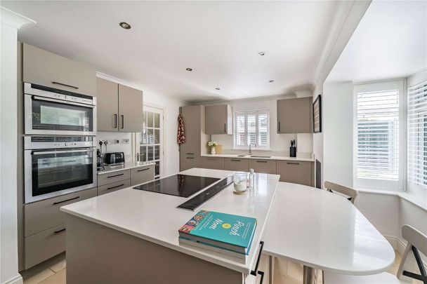 An immaculately presented four-bedroom detached family home with garaging. - Photo 1