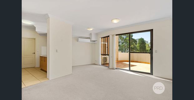 SUNDRENCHED TOP FLOOR UNIT IN CONVENIENT SETTING - Photo 1
