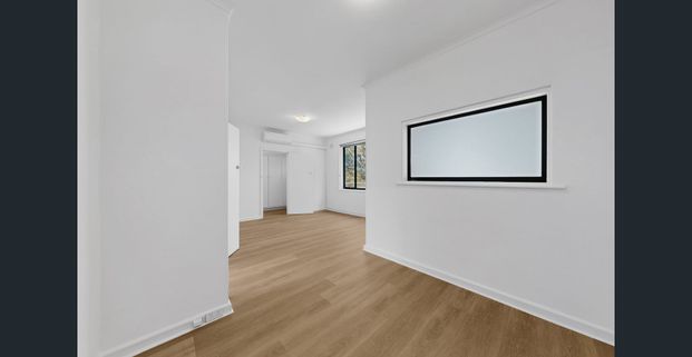 Spacious Top-Floor Apartment with Brand-New Updates Throughout - Photo 1
