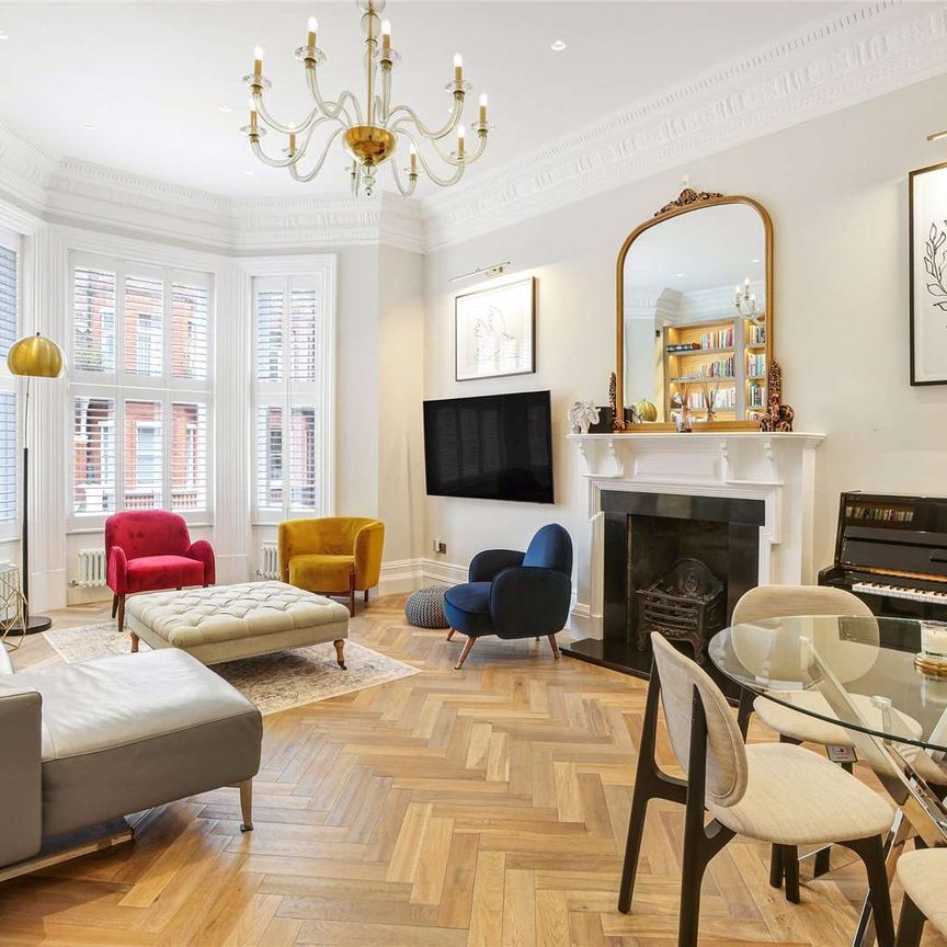 A stunning three-bedroom apartment, situated on the raised ground floor of an impressive red-brick building in South Kensington, benefitting from wooden floors and a private entrance. - Photo 1