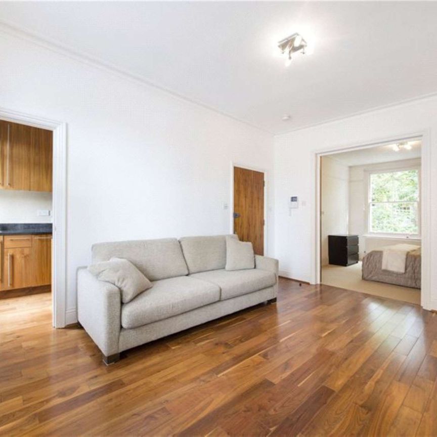 A modern first floor one bedroom apartment with wooden floors in the reception room. - Photo 1