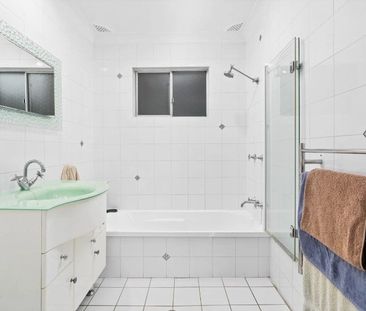 Family home with multiple living zones and large fenced yard - Photo 5