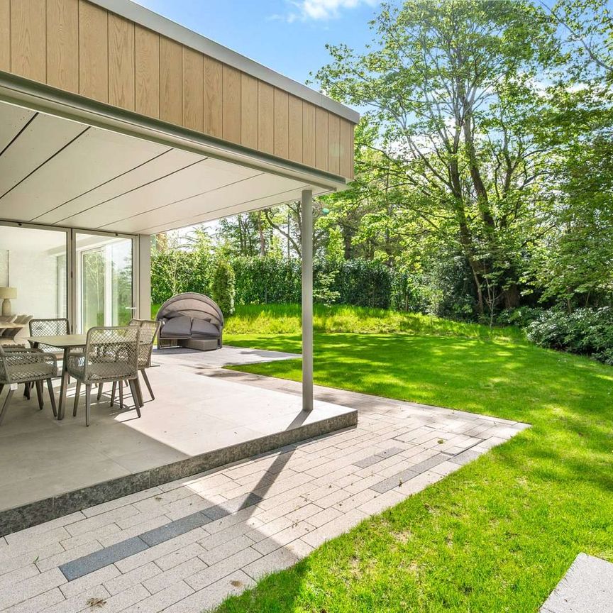 A landmark five-bedroom, five-bathroom residence set within generous south-facing gardens, located in one of the North West's most prestigious village settings. - Photo 1