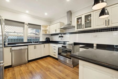 Stylishly updated north-to-rear facing home set on a tree-lined street - Photo 3