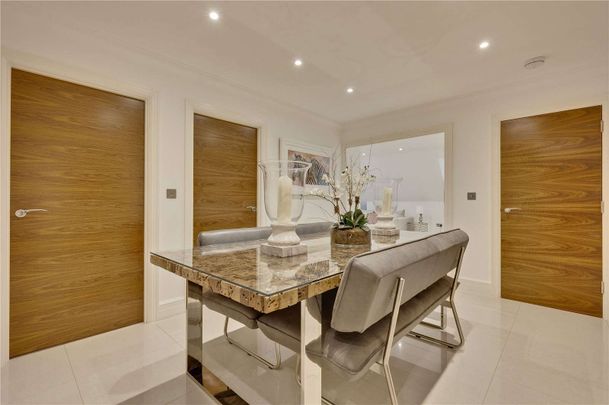 Contemporary apartment conveniently located within half a mile radius of Weybridge station and Queens Road amenities. Includes two underground parking spaces. - Photo 1