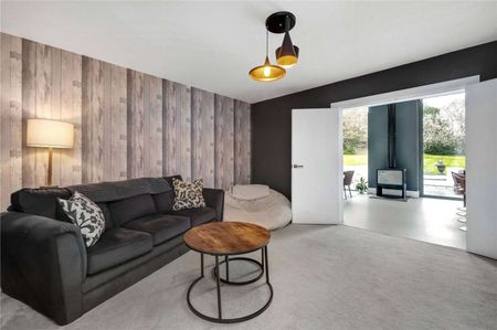A truly impressive family home in a popular residential road in Esher, offering stylish and modern living with 5 bedrooms, 3 bathrooms and 4 reception areas. - Photo 3