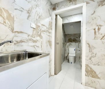 Modern Split-Level Townhouse-Style Apartment with Private Courtyard - Photo 1