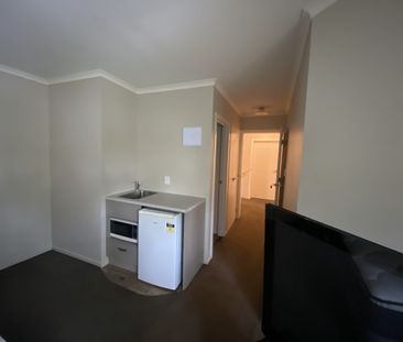 Furnished studio room featuring essential amenities such as a bed, ... - Photo 5