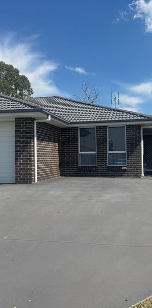 This immaculate two-bedroom unit is ideally located close to the Hunter Expressway, offering comfort and convenience. - Photo 2