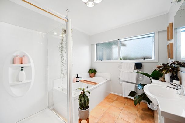 This modern four-bedroom, two-bathroom home offers the perfect blend of comfort and convenience. - Photo 1